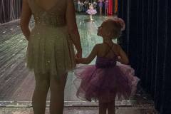 Under the tutelage of an older dancer a young ballerina waits for her cue to join other dancers on stage during recital rehearsals for Generations end of year performance. My Final Photo for May 2, 2014.