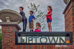 A group of kids watching dancers in front of Generations use the Uptown sign at City Hall for an unobstructed view of College Ave. My Final Photo for April 17, 2017.