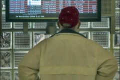 Man inspects arrival and departure boards at Columbus International airport. My Final Photo taken  Nov. 24, 2004.Photo Copyright 2004 Gary Gardiner. Not to be used without written permission detailing exact usage. Photos from Gary Gardiner, may not be redistributed, resold, or displayed by any publication or person without written permission. Photo is copyright Gary Gardiner who owns all usage rights to the image. Low resolution photo with watermark.