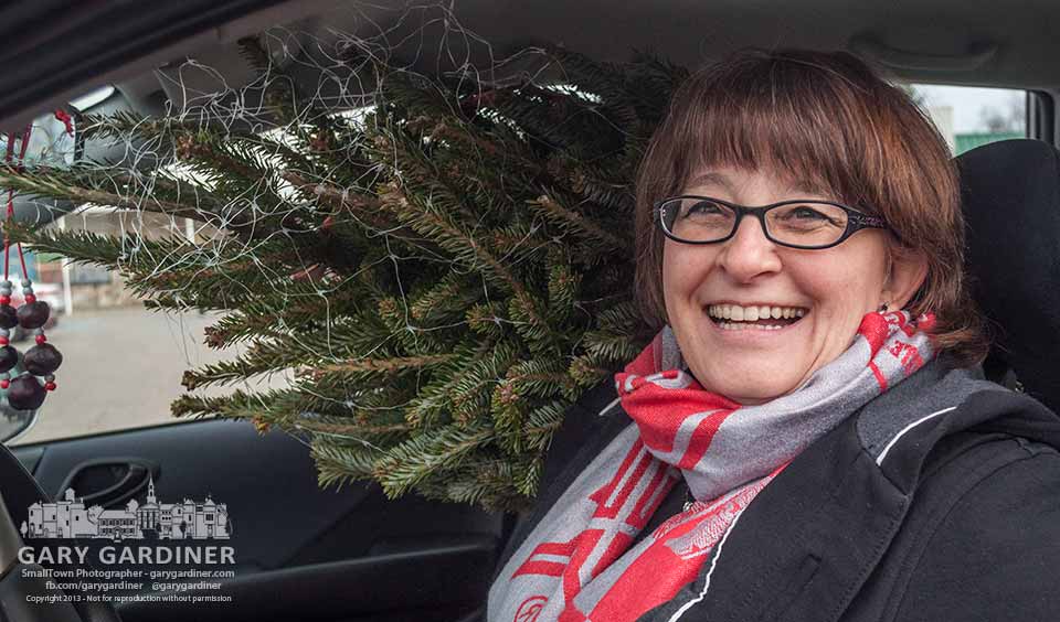 An eight-foot Christmas tree extends into the passenger seat of the celebrant's car after she bought it at a tree lot. My Final Photo for Dec. 1, 2013.