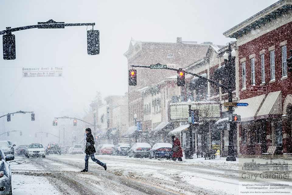 A shopper braves a strong winter snow squall as he crosses State Street in Uptown Westerville. My Final Photo for Jan. 25, 2014.