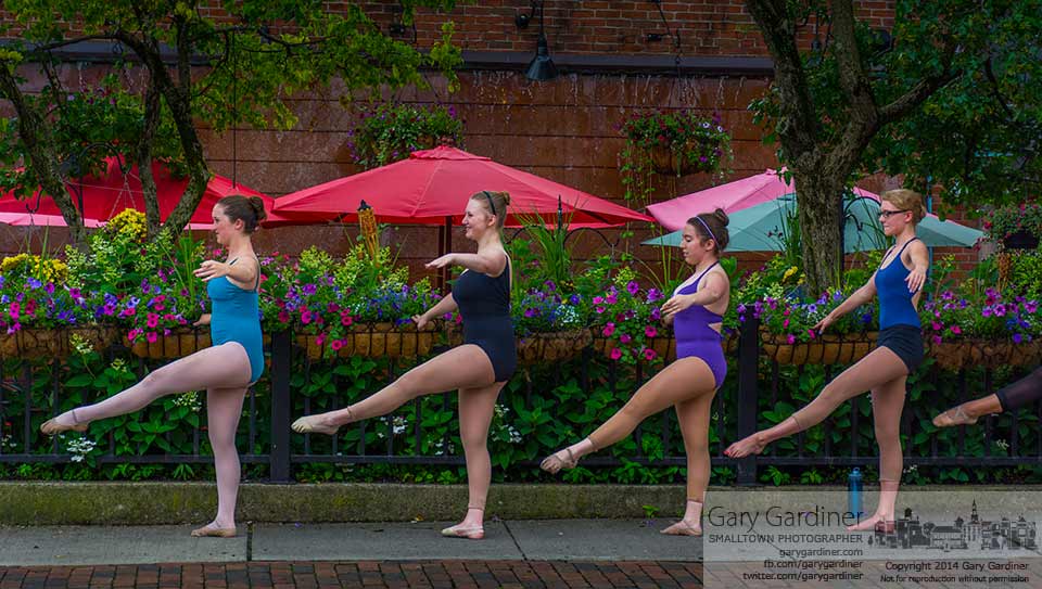 Dancers from Generations use the flower baskets along Jimmy V's patio wall as their barre as they practice outdoors during a summer class. My Final Photo for June 25, 2014.