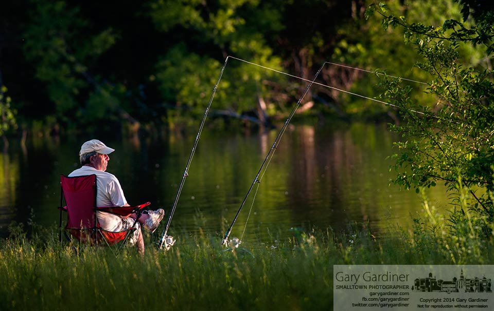 A fisherman sits in the morning light along the shoreline at Hoover Reservoir.y final Photo for June 6, 2014.