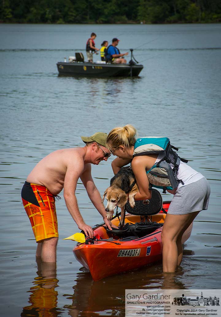A water bound couple places their dog in a kayak where he will get tour of Hoover Reservoir. My Final Photo for July 5, 2014.