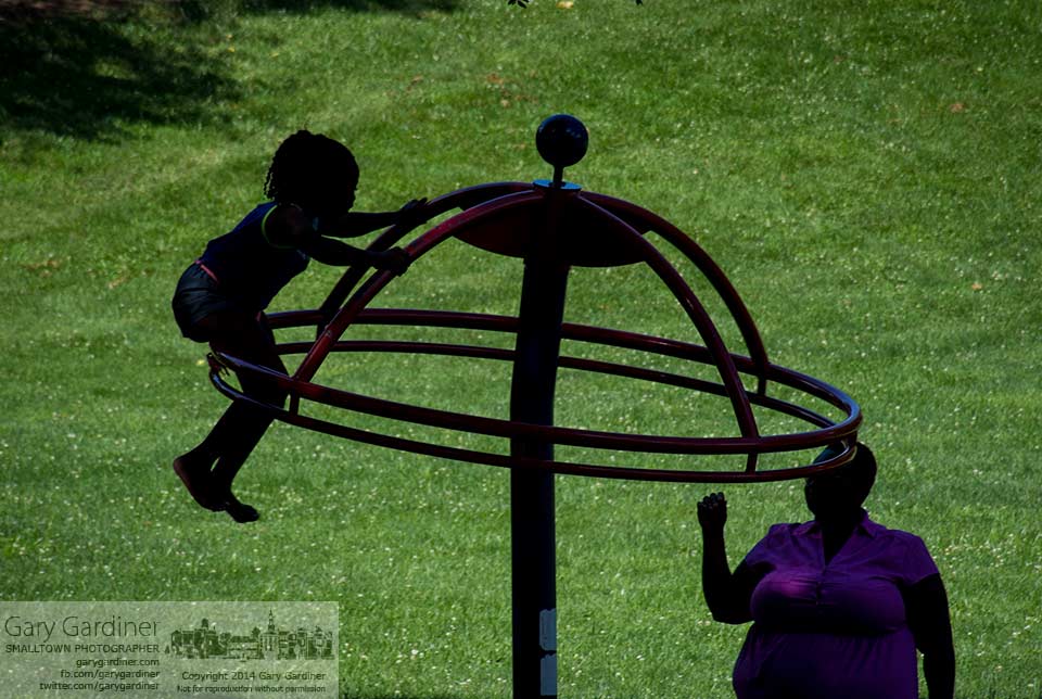 Mother and daughter  play on one of the playground toys at Alum Creek Park in Westerville. My final Photo for July 15, 2014.