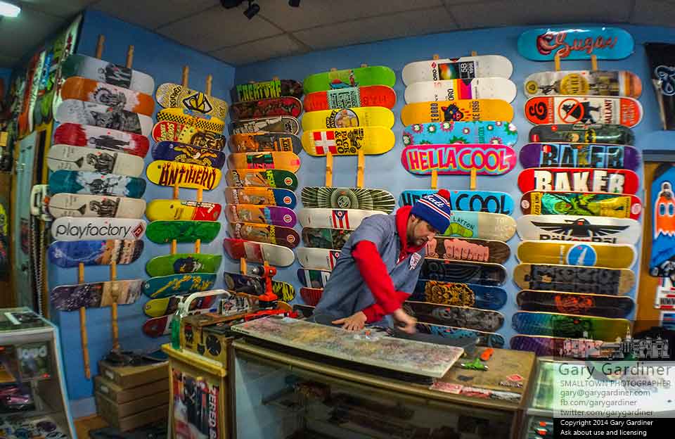 A frequent customer rebuilds his skateboard at Old Skool Skateshop in Uptown Westerville. My Final Photo for Dec. 3, 2014.