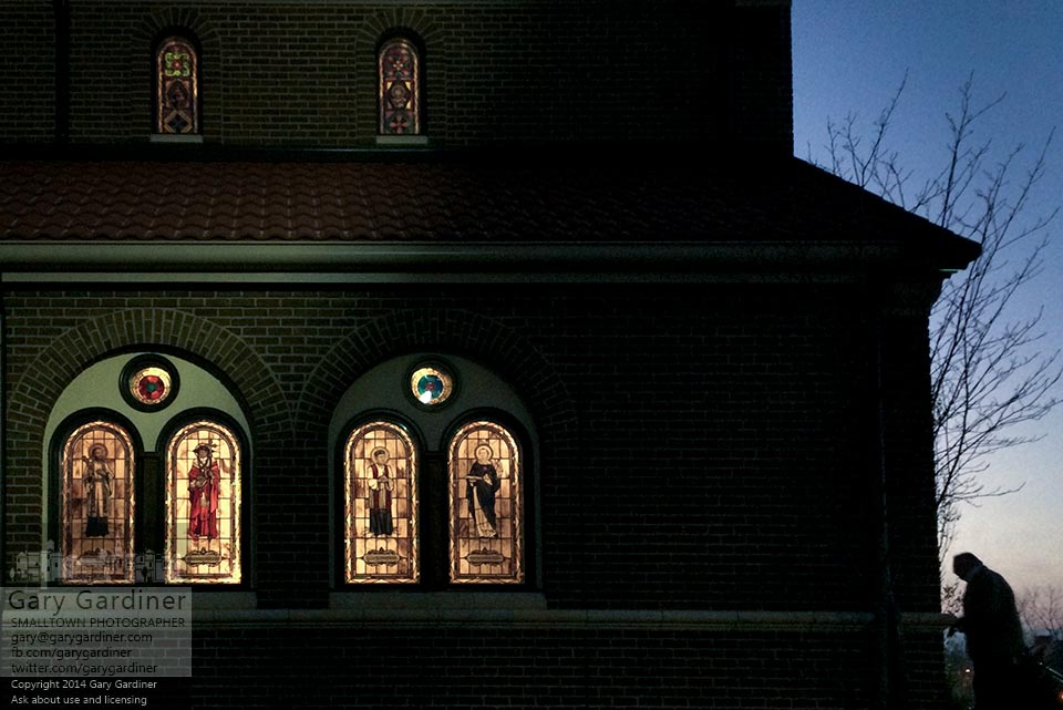 A parishioner enters one of the side doors of st. Paul the Apostle Catholic church for the first Mass on a Sunday morning. My Final Photo for Dec. 21, 2014.