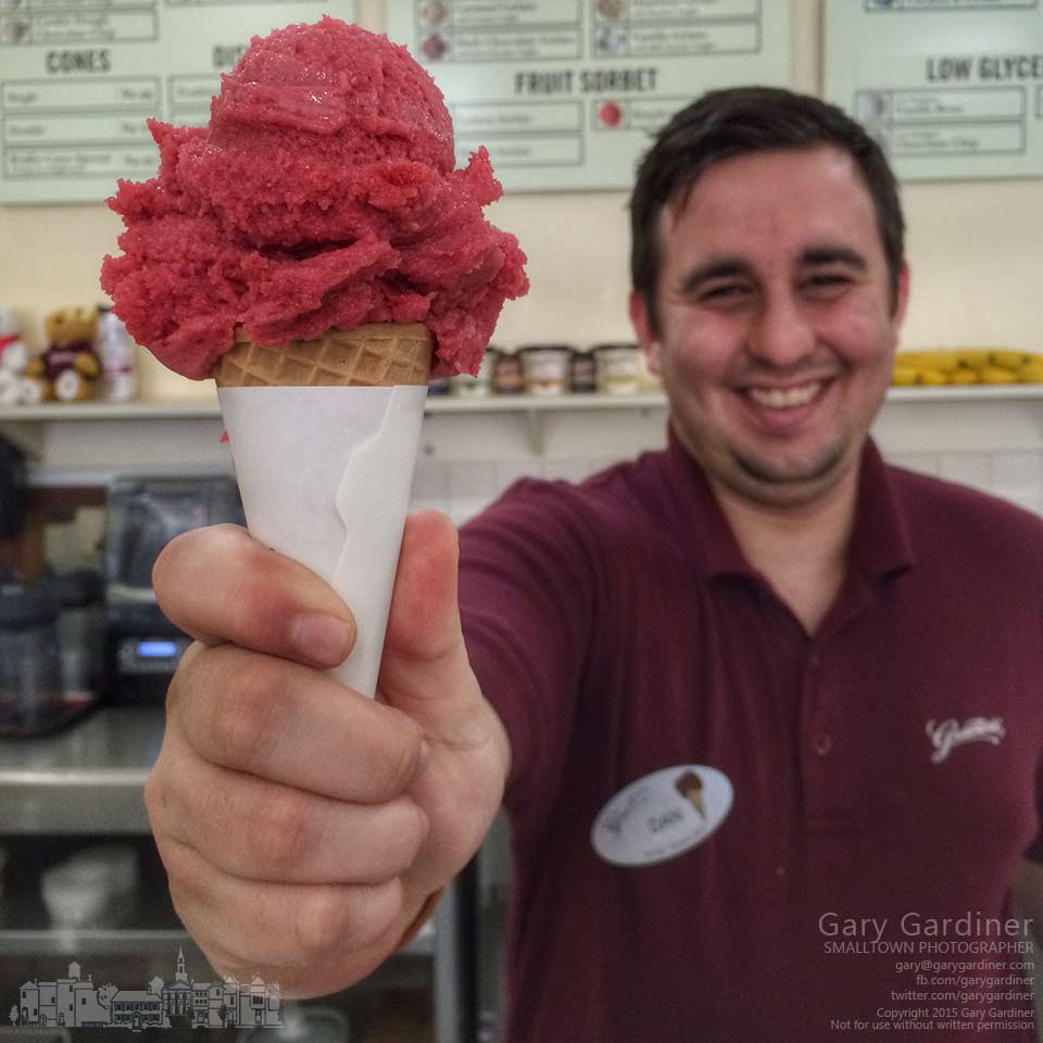 Dan at Graeter's Ice Cream in Uptown Westerville serves a scoop of raspberry sorbet to a customer on Fat Tuesday, the celebration before the beginning of Lent on Wednesday. My Final Photo for Feb. 17, 2015.