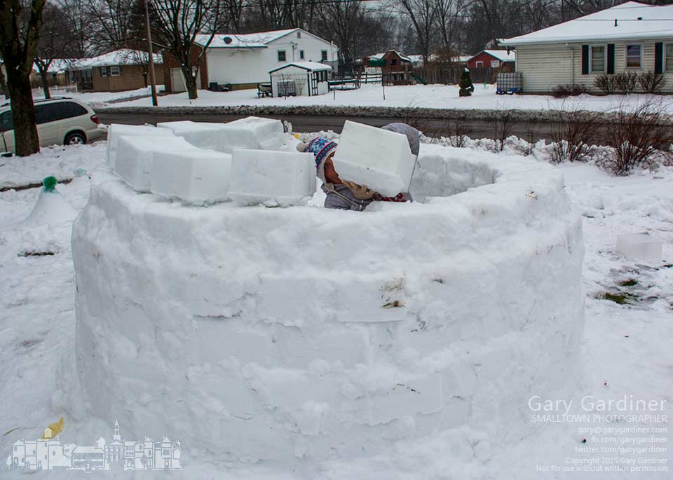 Dawn places another block of snow onto the walls forming an igloo in the front yard of her home on Otterbein Ave. My Final Photo for March 3, 2015.