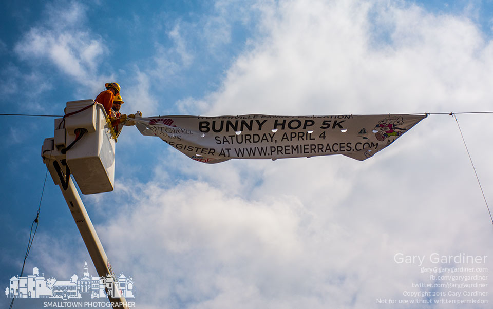 City workers remove the Bunny Hop 5K banner over State Street at Main after it was damaged by high winds as a cold front moved into central Ohio. My Final Photo for March 31, 2015.