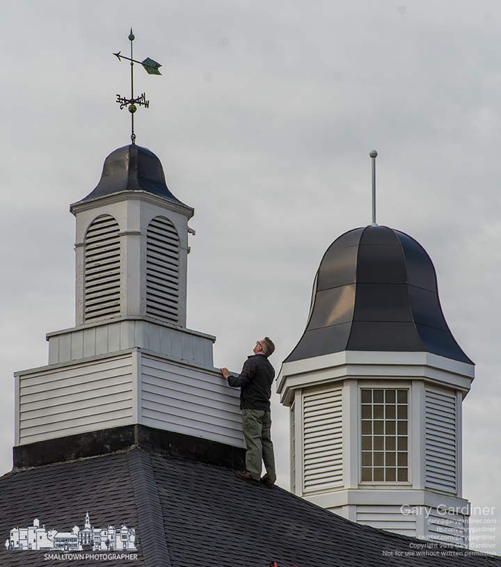 A roofing contractor inspects the spire at the top of the original city hall building on South State St. My Final Photo for April 15, 2015.