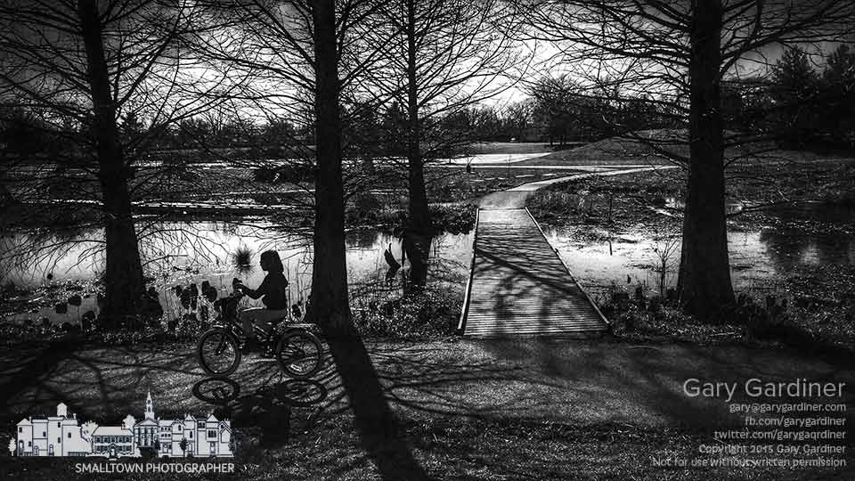 A young girl rides her bike around the sidewalks at Highlands Park on a warm spring afternoon. My Final Photo for April 1, 2015.