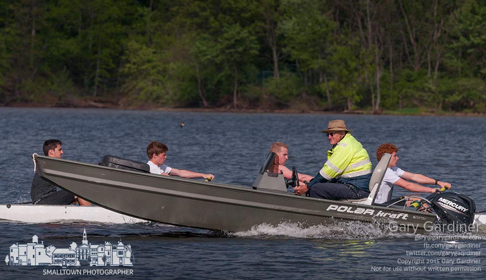 Westerville Crew head coach Matt Chase navigates beside one of the crews practicing on Hoover Reservoir in preparation for the next competition. My Final Photo for May 12, 2015.