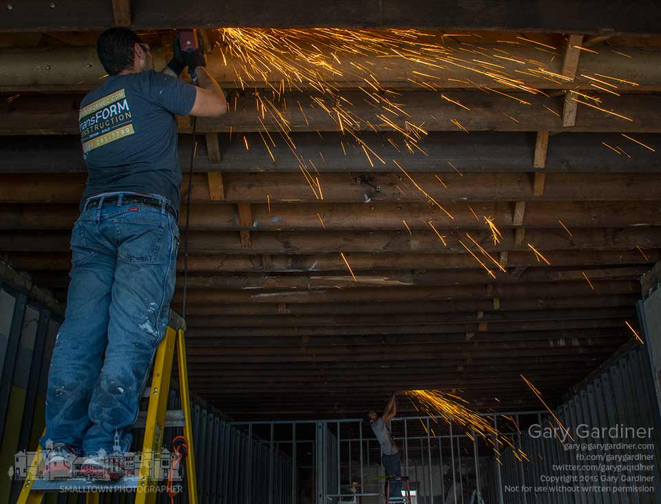 Demolition workers cut away pieces of galvanized plumbing pipe at the old location for Outside Envy in Uptown Westerville where a gourmet popcorn shop will be built. My final Photo for Aug. 18, 2015.