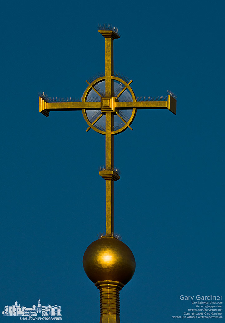 A near-full moon lines up behind the cross at the top of St. Paul the Apostle Catholic Church in Westerville, My Final Photo for Aug. 2, 2015.