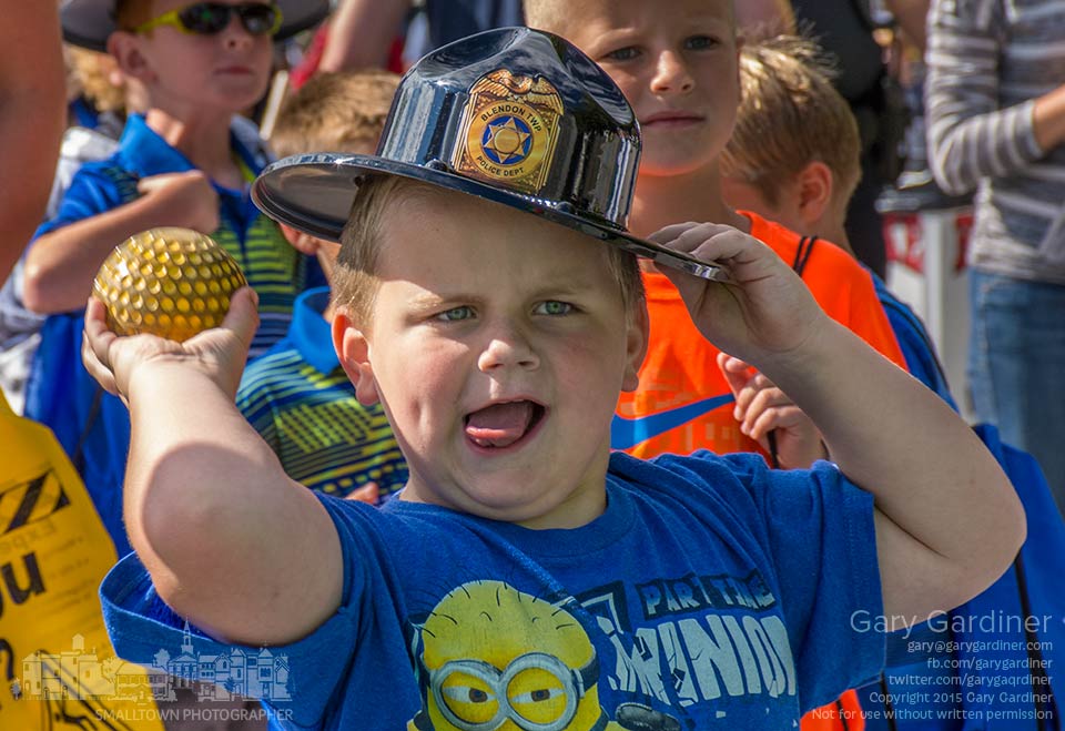 A youngster holds on to his Blendon Township police hat as he tosses a ball to drop Westerville Police Chief Joe Morbitzer into the dunk tank at Cops and Kids Day at Hoff Woods park. My Final Photo for Sept. 13, 2015.