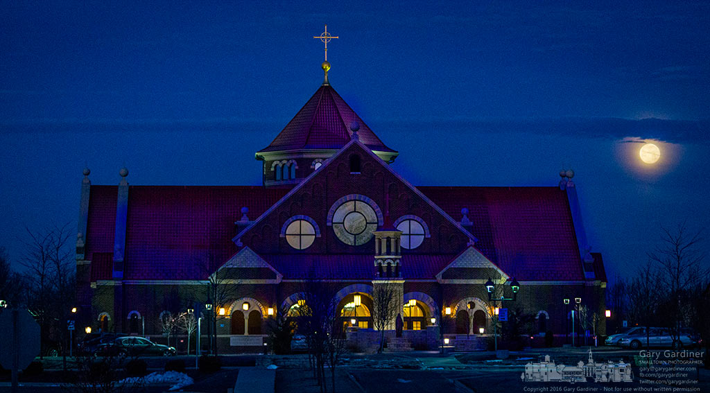The full moon slides below a low cloud as it moves to set on the horizon behind St. Paul Catholic Church. My Final Photo for January 24,2016.