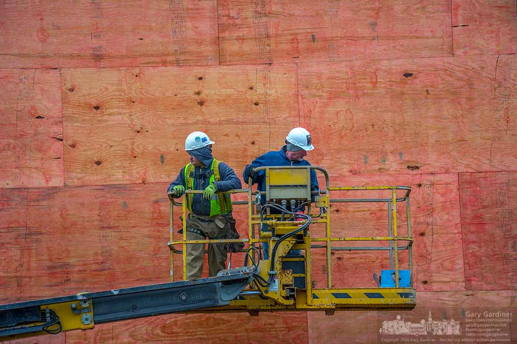 Construction workers move a lift into position to install another section of exterior wall plywood for the first covering at Northstar Cafe in Uptown Westerville. My Final Photo for February 4, 2016.