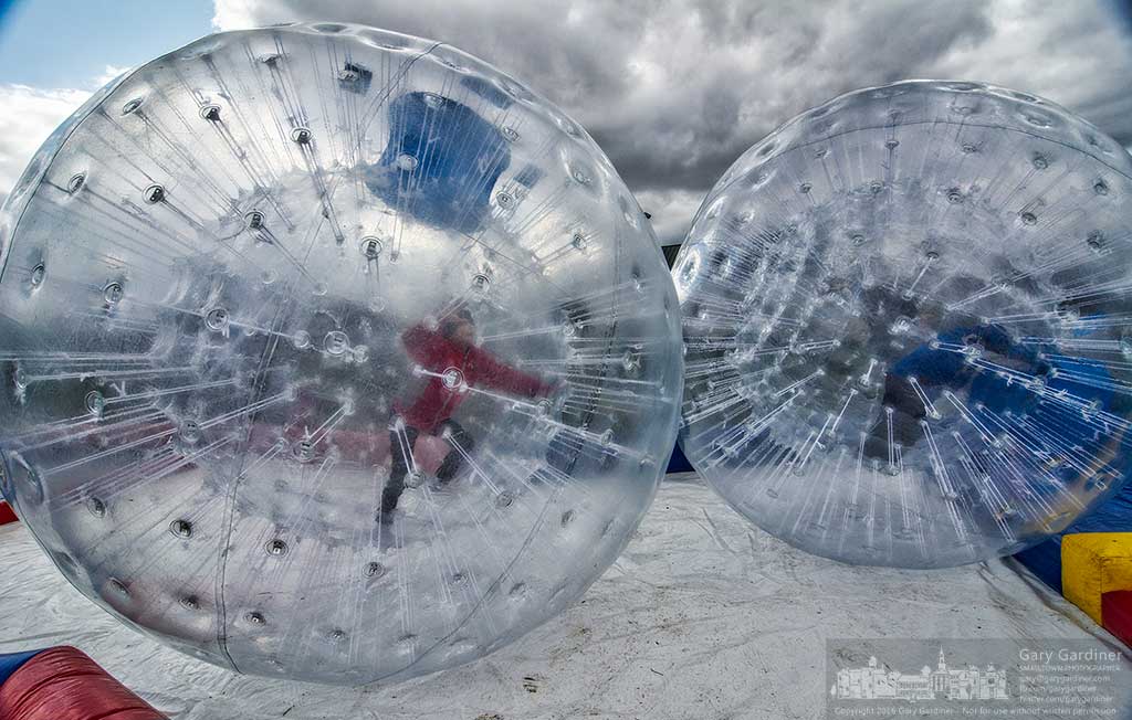 A pair of kids battle each other from inside inflated hamster balls as they pass through the crossover section of the game at the Church of the Messiah Easter Egg Hunt at Everal Barn. My Final Photo for March 20, 2016.