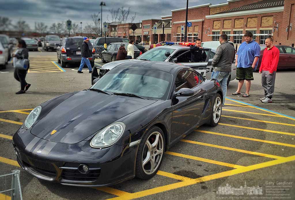 A Westerville police officer talks with  man who parked his Porsche in the striped parking space between handicapped spots in front of Walmart. My Final Photo for March 6, 2016.