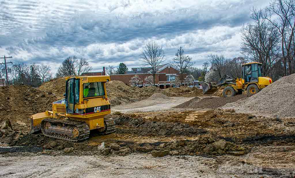 Contractors remove dirt to level a field for an extension of the library parking lot. My Final Photo for March 30, 2016.