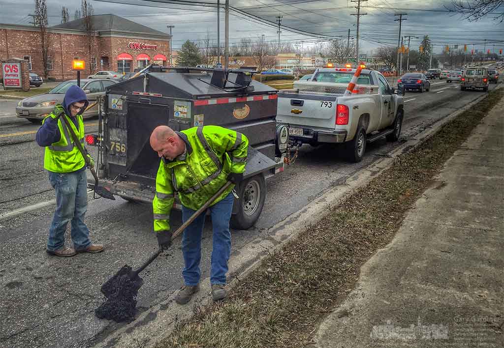 City workers fill potholes on Cleveland Ave. with hot asphalt hoping to make the path smoother for motorists who will soon discover the roadway at Cleveland and Schrock a construction zone as the interchange is widened and upgraded. My Final Photo for March 3, 2016.