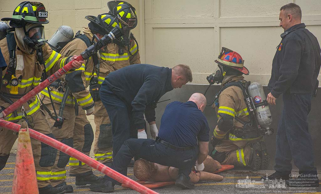Fire fighters and medics work around a rescue dummy during training exercises in Uptown Westerville Saturday morning . My Final Photo for April 30, 2016.