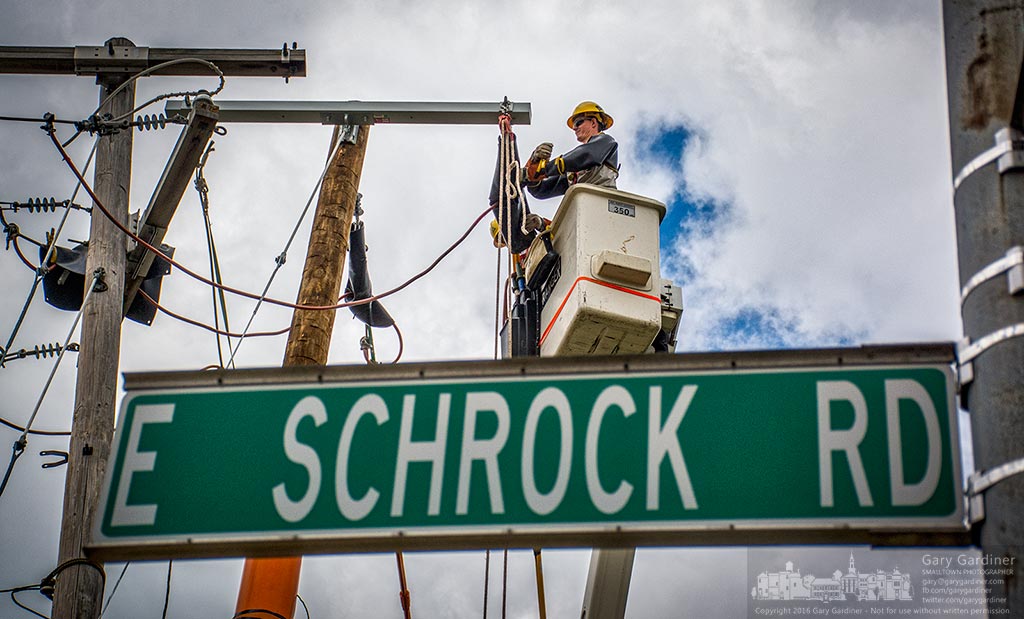 A city electrician reroutes overhead power lines to a new pole at East Schrock and Otterbein where new underground utilities will terminate when construction is completed on the changes at State and Schrock. My Final Photo for May 13, 2016.