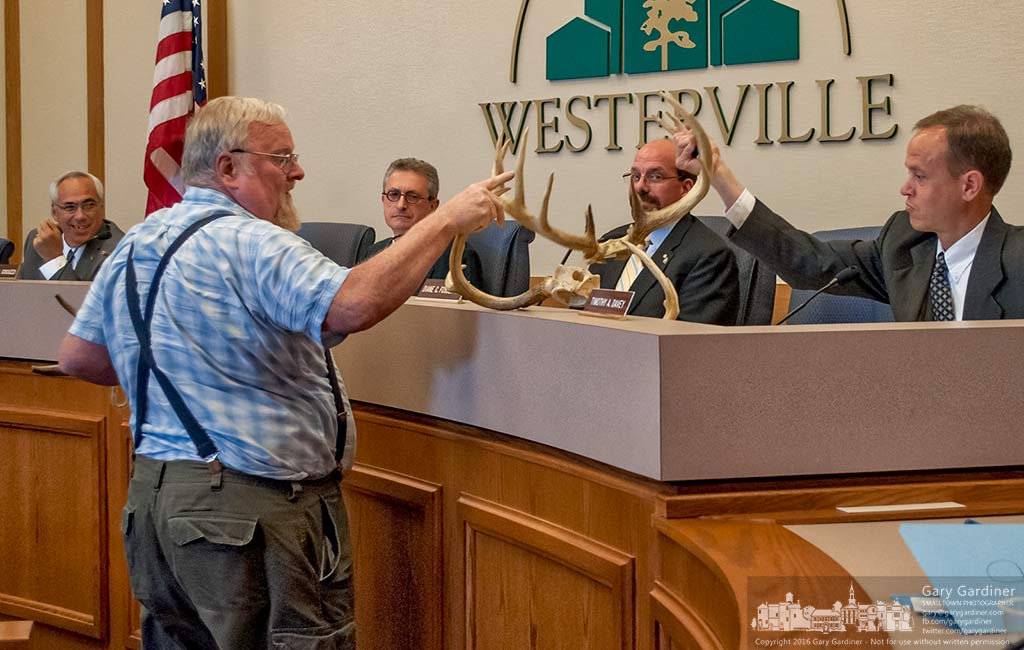 Farmer David Law shares deer antlers with Westerville City Council after speaking to them about the dangers of large deer herds and traffic crashes. My Final Photo for June 21, 2016.