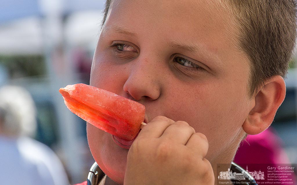 This young man uses a J-Pop Ice pop to cool off while shopping with his mom at the Uptown Westerville Farmers Market . My Final Photo for June 29, 2016.