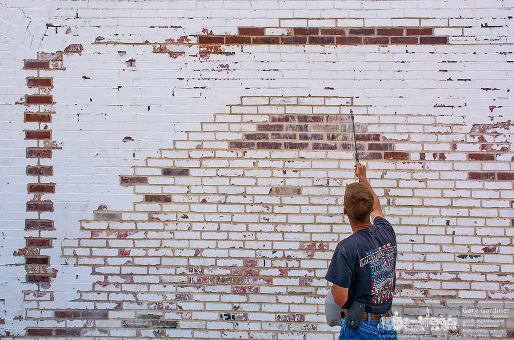 A worker sprays water on fresh mortar used to repair the brick wall of the Westerville Visitors and Convention Bureau after it was damaged in a car crash. My Final Photo for June 17, 2016.