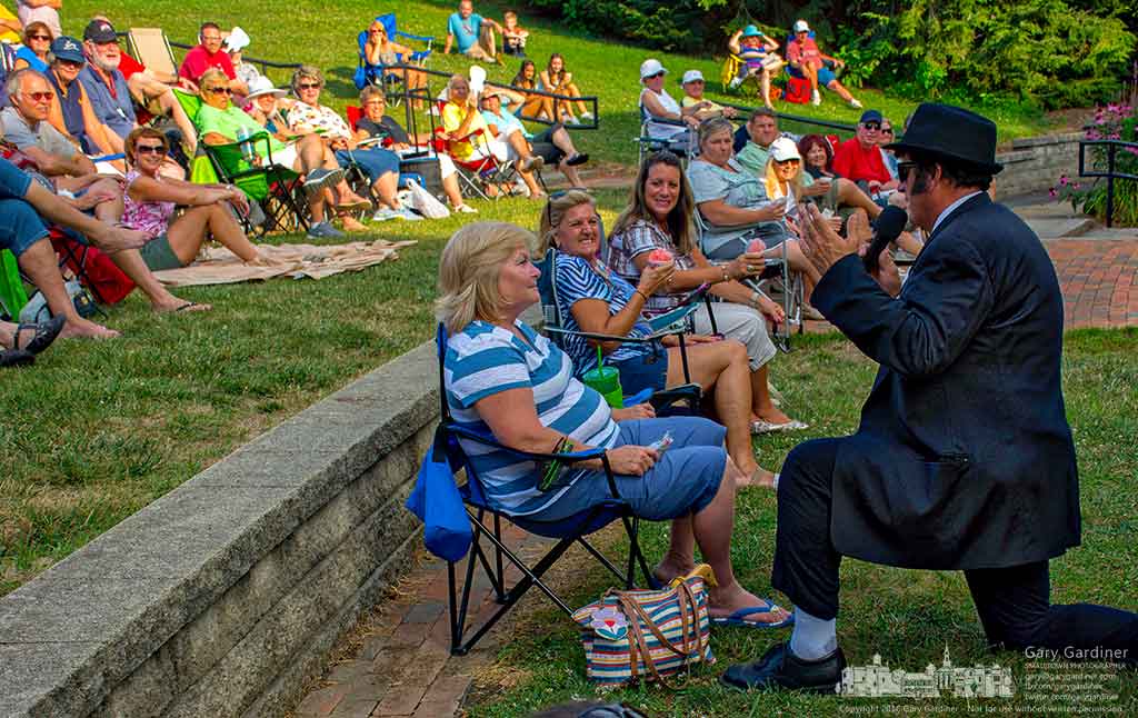 “Joliet” Jake E. Blues kneels in front of the woman falsely identified as an old girlfriend during Sunday evening’s Blues Brothers Tribute in Alum Creek Park North in Westerville, Ohio. My Final Photo for July 31, 2016.