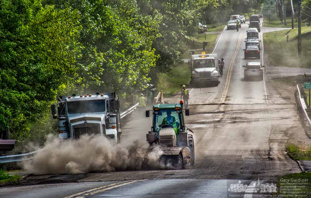 A work crew clears debris from the Dempsey Road Bridge after milling away the old asphalt surface preparing it for repaving next week. My Final Photo for August 13, 2016.