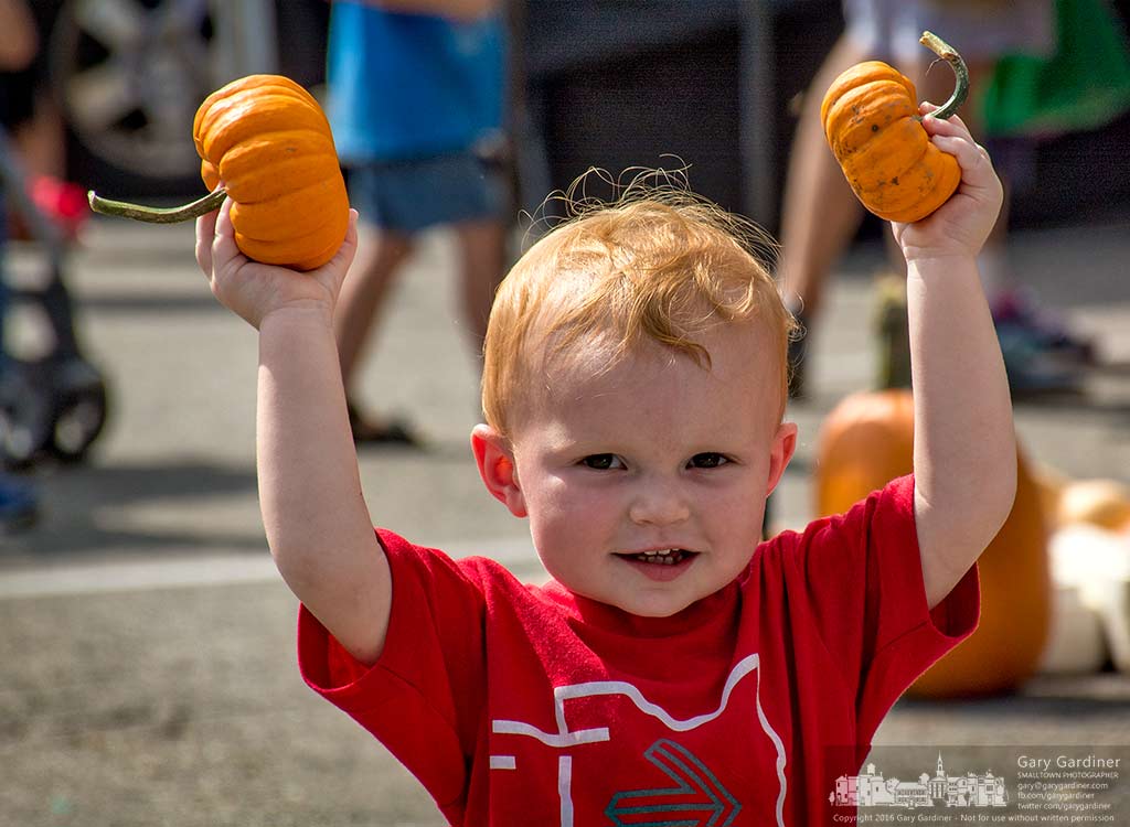 A young boy proudly displays the small pumpkins chosen for him at the Doran’s Farm booth at the Uptown Westerville Farmers Market. My Final Photo for August 31, 2016.