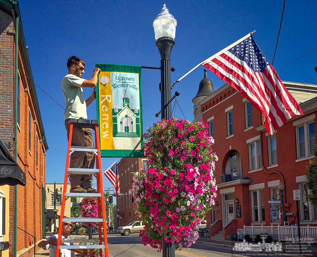 A Westerville electric division worker replaces summer’s banners with fall related banners on light poles in Uptown Westerville marking the end of summer. My Final Photo for Sept. 21, 2016.