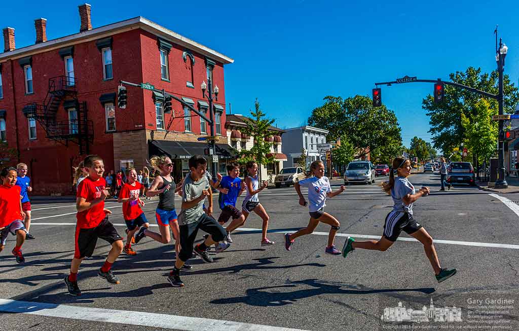 A troop of runners cross State at College after waiting for the traffic signal to turn red permitting them to continue on their afternoon training session. My Final Photo for Oct. 10, 2016.