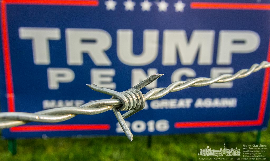 A barbed wire fence surrounds a Trump-Pence campaign sign in Columbus, Ohio, Friday. My Final Photo for Oct. 21, 2016.