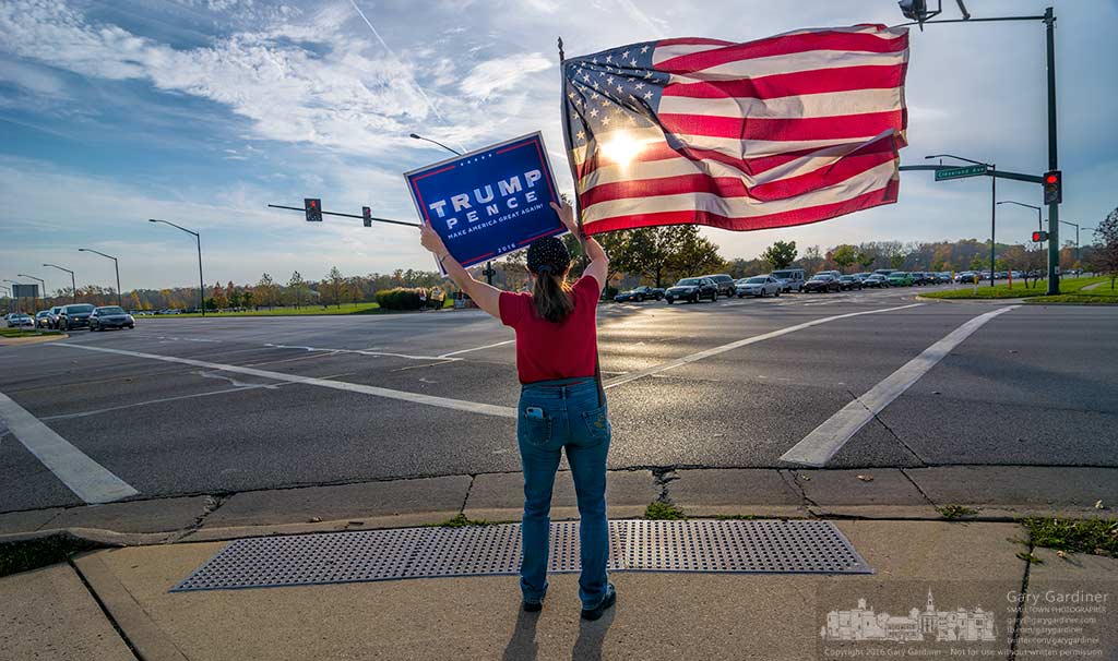 One of about ten Trump supporters at Cleveland and County Line waves a flag and holds a Trump campaign sign during rush hour one week before the election. My Final Photo for Nov. 1, 2016.
