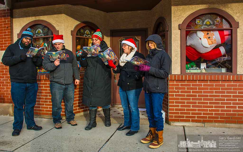A quintet of carolers appear to be watched by an inflateable Santa as they made their way through Uptown Westerville Sunday singing four-part harmony Christmas Carolers. My Final Photo for Dec. 16, 2016.