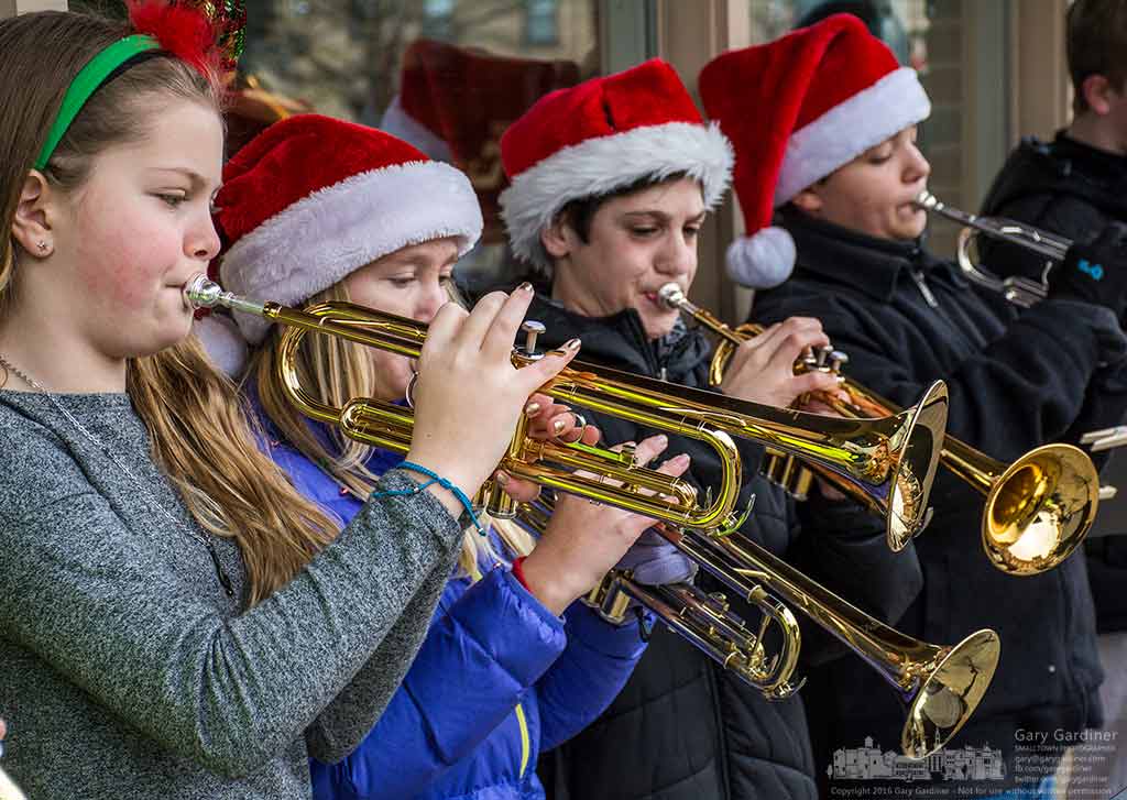 An orchestra of youthful trumpeters perform on the sidewalk in front of Music & Arts in during Saturday’s Home for the Holiday celebrations in Uptown Westerville. My Final Photo for Dec. 10, 2016.