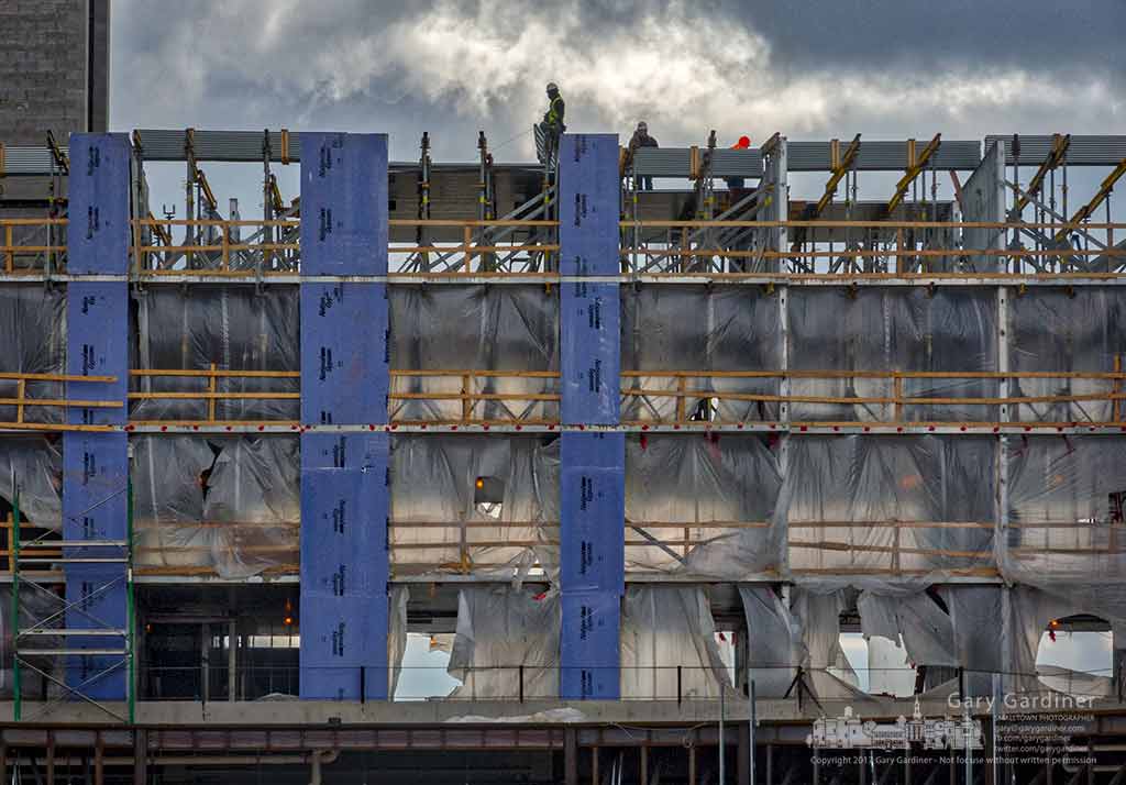 Construction works lay metal panels across the top of the fifth floor walls at the Marriott Renaissance Hotel being built in Westar along Polaris Parkway. My Final Photo for Jan. 30, 2017.