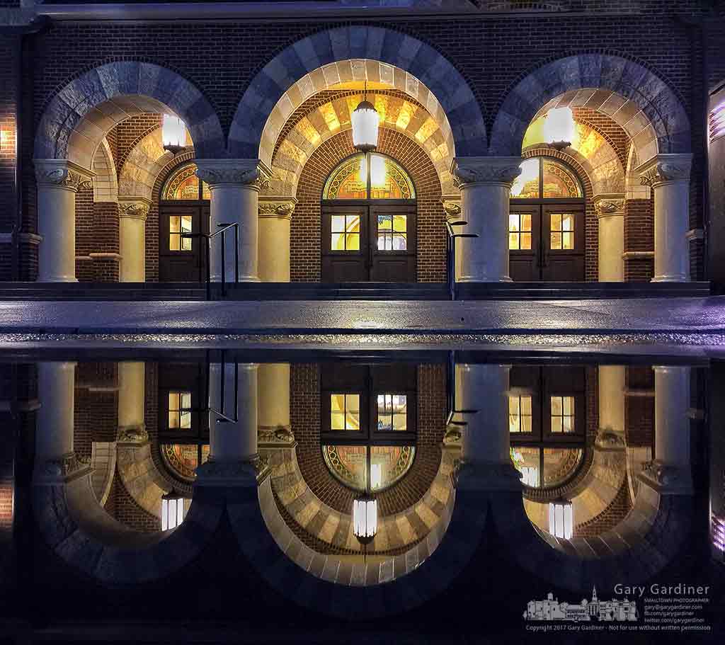 The doors of St. Paul the Apostle Catholic Church are reflected in a puddle from overnight rain before the early morning Mass on Sunday. My Final Photo for Feb. 12, 2017.