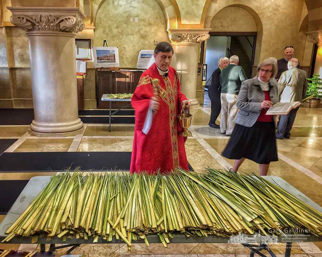 Father Rod Damico blesses palm fronds with Holy Water before the first Mass on Palm Sunday at St. Paul the Apostle Catholic Church in Westerville. My Final Photo for April 9, 2017.
