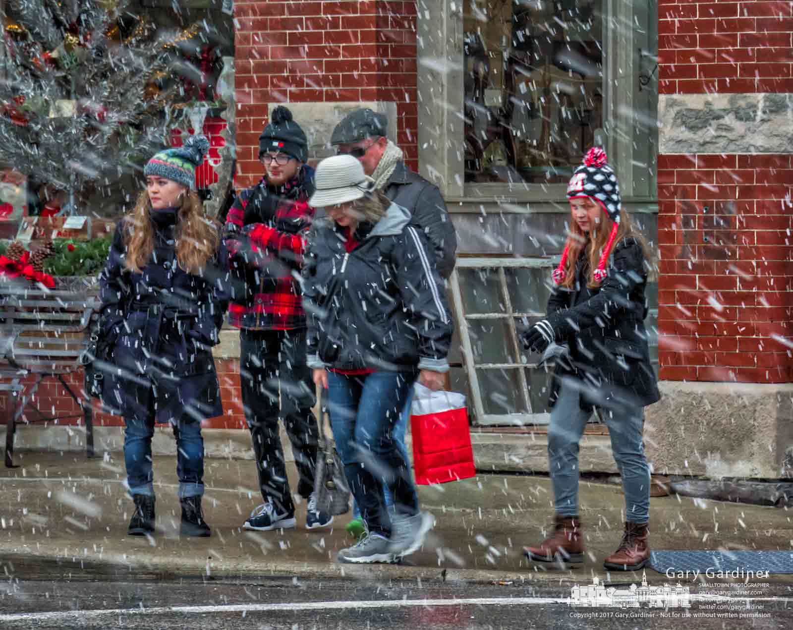 Shoppers in Uptown Westerville navigate their way a through a snow squall as they cross State Street at College Ave. My Final Photo for Dec. 23, 2017.