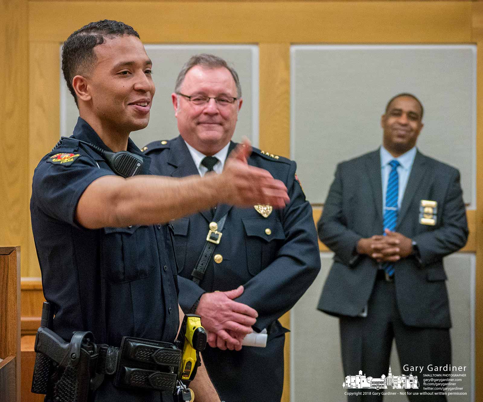 Khyrell Baggoo thanks his family for their support after he was sworn in as Westerville's newest police officer during city council meeting. Behind him is Police Chief Joe Morbitzer. At rear is Asst. Chief Anthony Wilson. My Final Photo for Feb. 20, 2018.