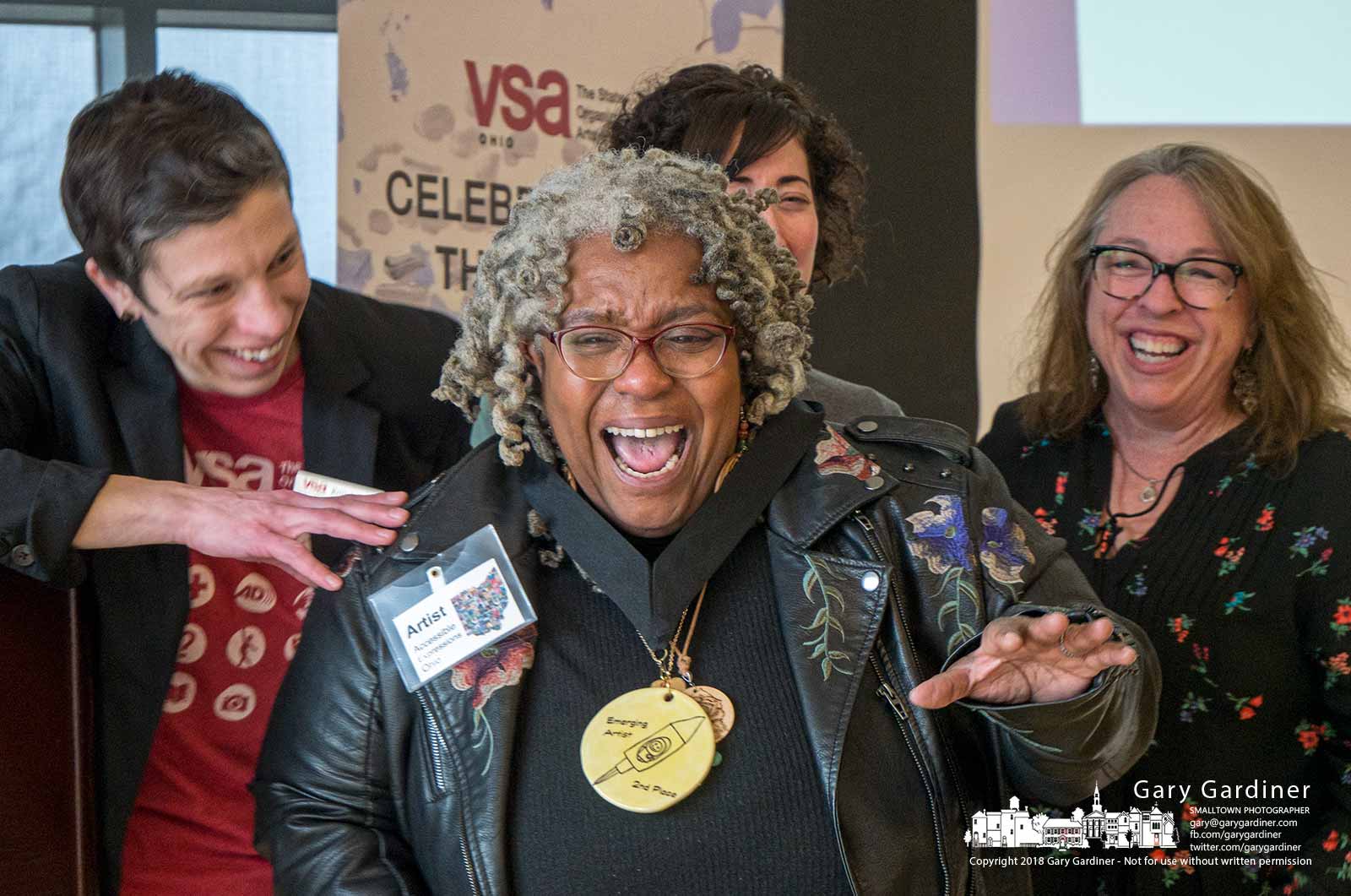 Regina Dorfmeyer expresses her joy after winning second place in the emerging artist category of the Artistic Expressions Ohio exhibit at the Community Center sponsored by VSA Ohio. My Final Photo for March 24, 2018.