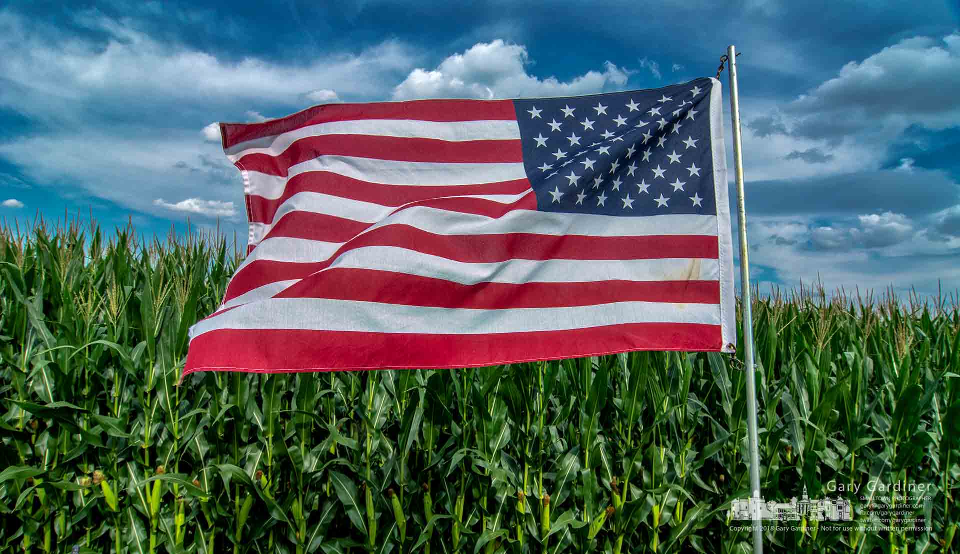 The American flag flies along a cornrow at the edge of the Yarnell farm fields on Africa Road. My Final Photo for July 26, 2018.