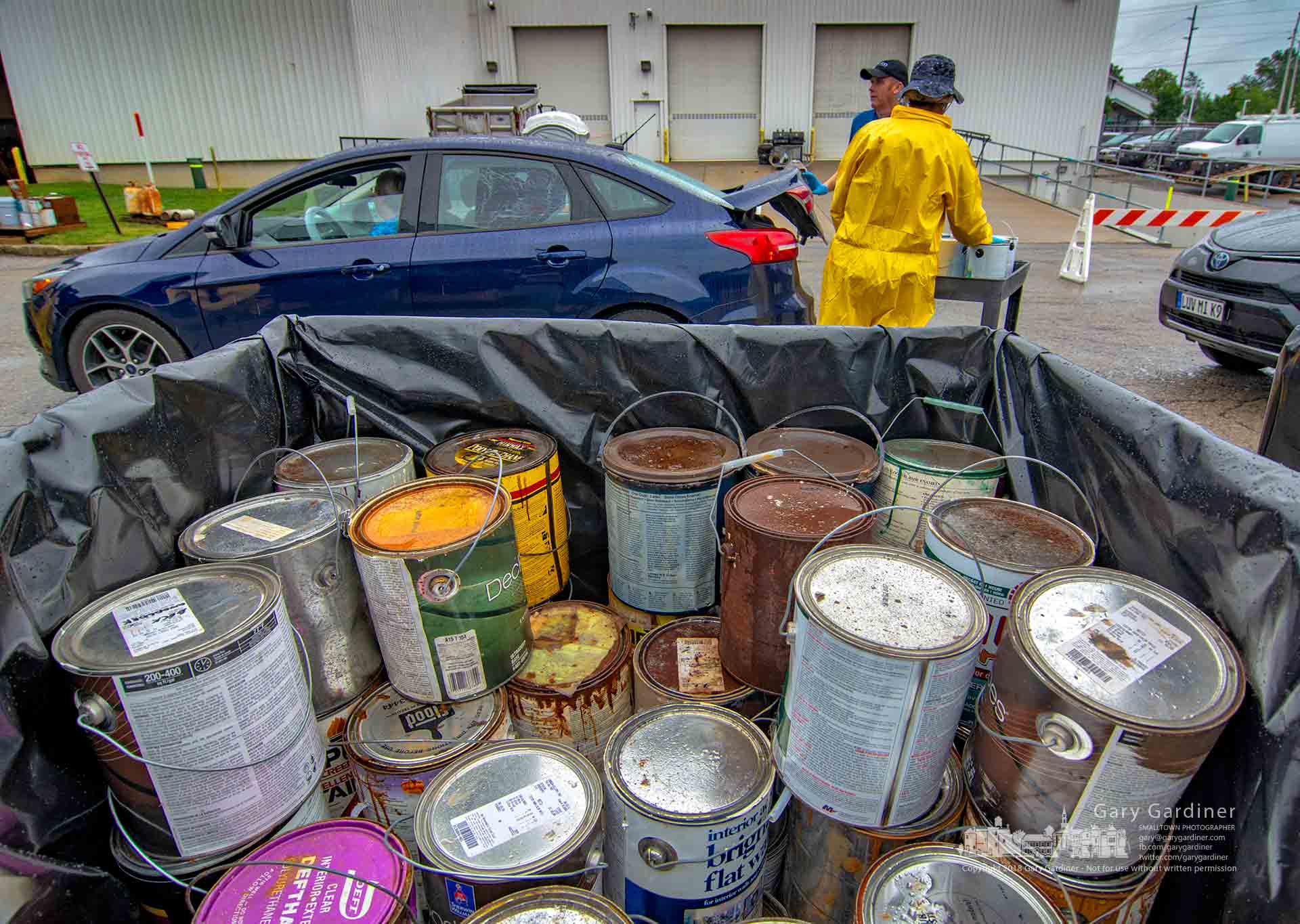Solid Waste Authority of Central Ohio workers unload a car carrying household hazardous waste including old paint cans at the city's twice-yearly disposal event at the city garage. My Final Photo for Sept. 8, 2018.