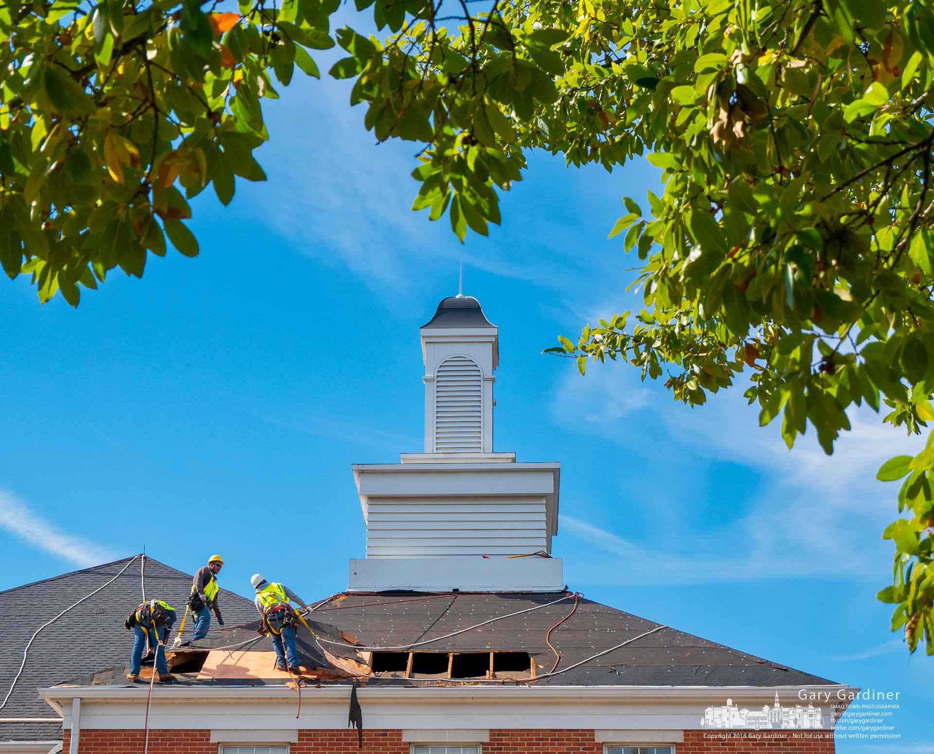 A roofing work crew replaces rotting plywood on the roof of the police department building before replacing the shingles in the second part of a multi-year project to upgrade the building. My Final Photo for Oct. 22, 2018.