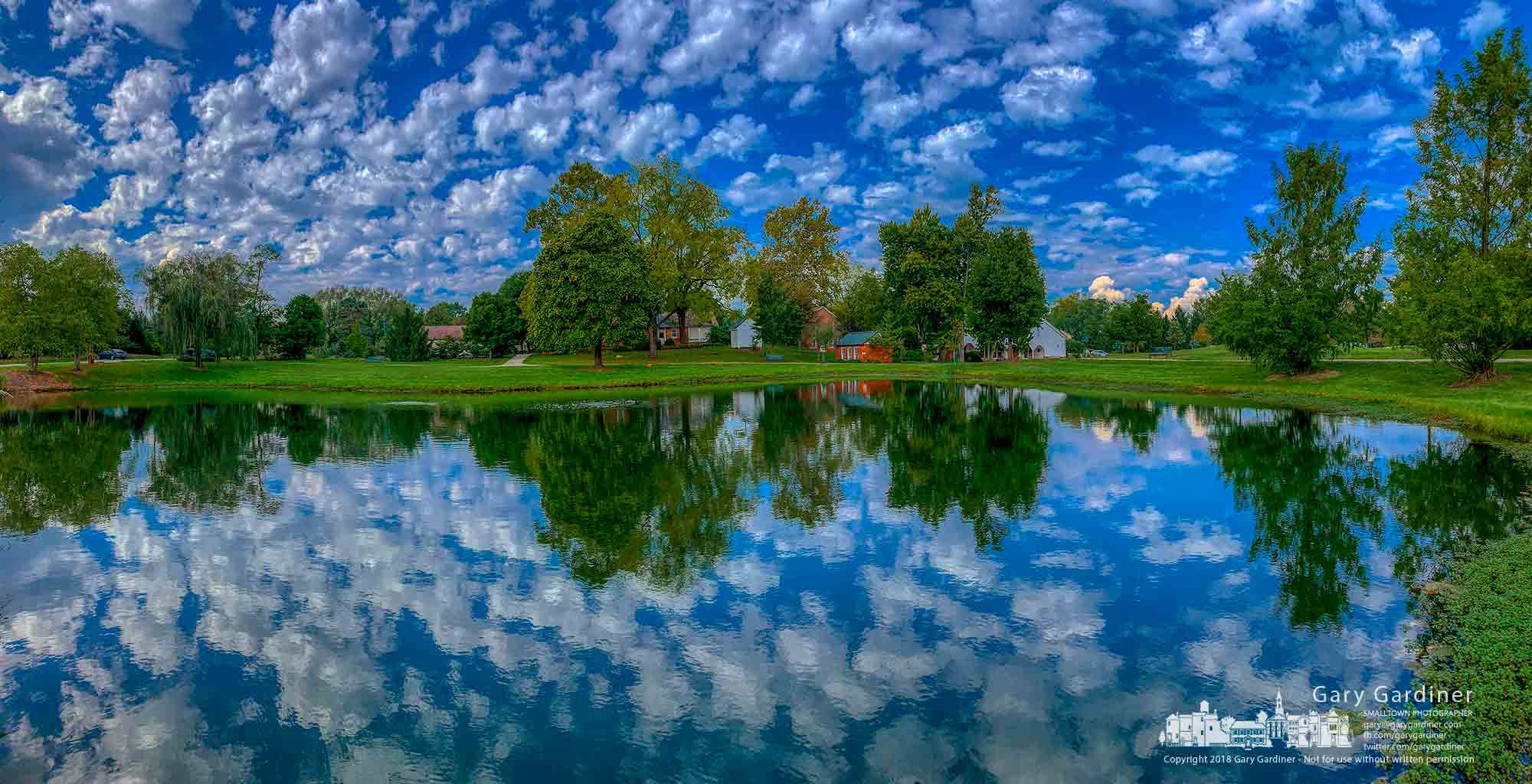 Noon-hour clouds slide across the sky over the pond at Heritage Park in Westerville a few hours before a wedding on the grounds. My Final Photo for Oct. 6, 2018.